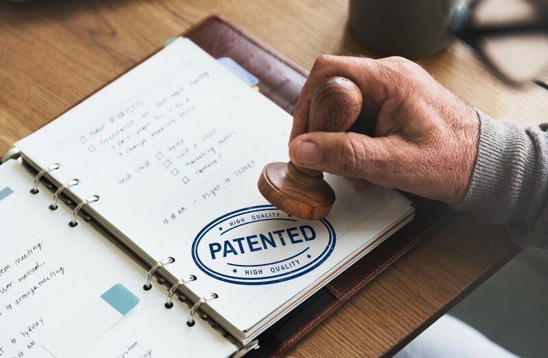Investors reviewing startups’ due diligence documents, including patents.