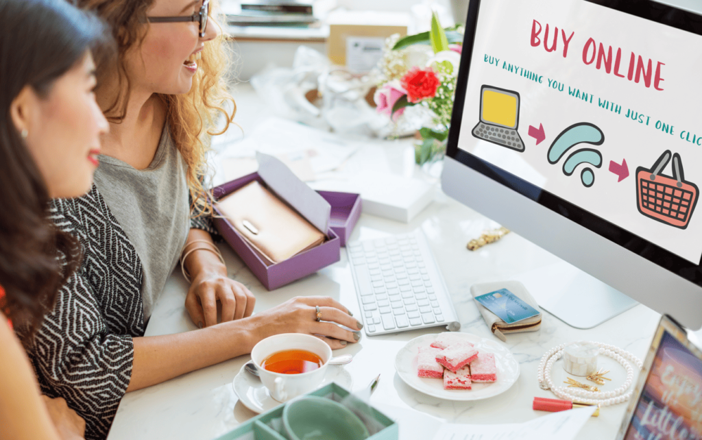 Two women working at a desk looking at an e-commerce screen, illustrating multilingual content marketing localization in SEA.