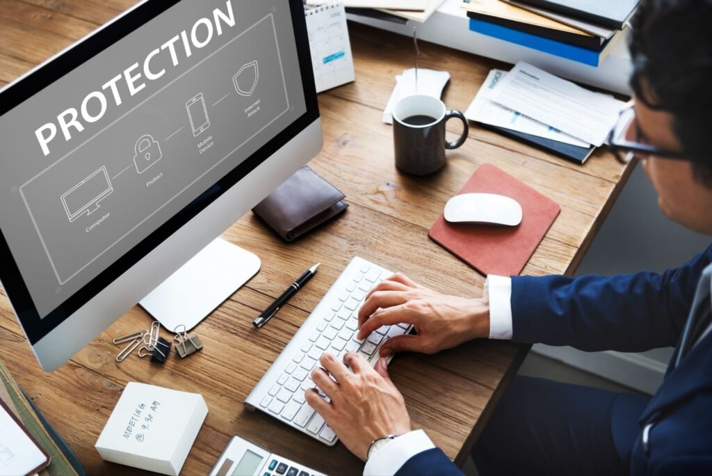 A professional working on a computer displaying a "PROTECTION" security flowchart, illustrating the specialized nature of patent translation.