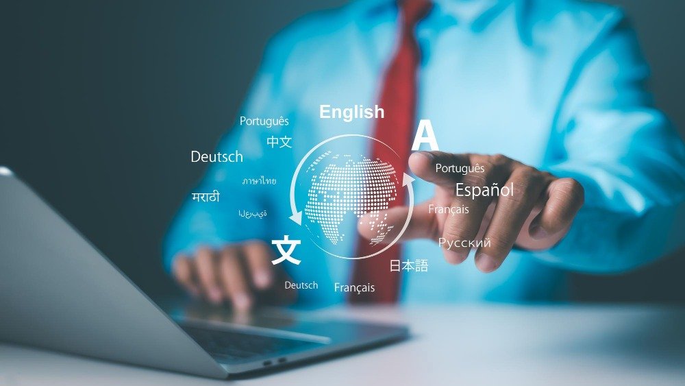 A professional reaching toward a digital globe surrounded by multiple language names above a laptop, representing SpeeQual's certified translation services in Malaysia.