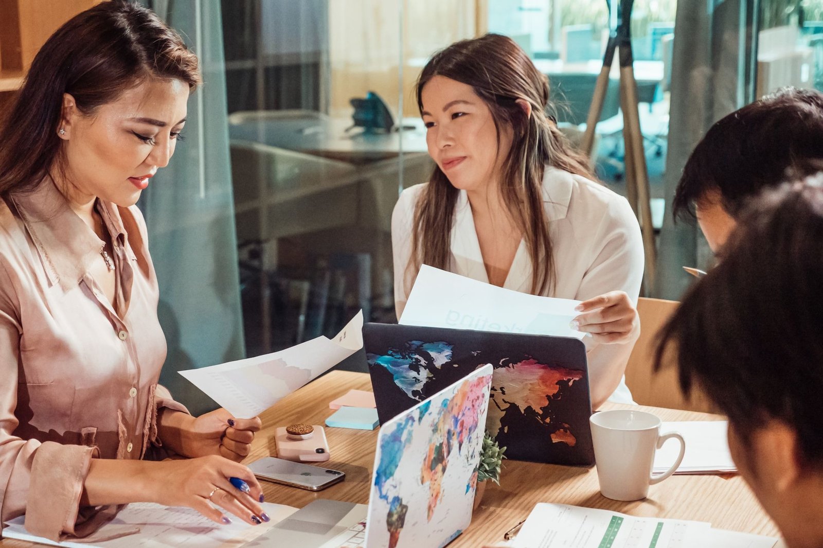 Professionals examine papers and digital files as part of the document translation process.