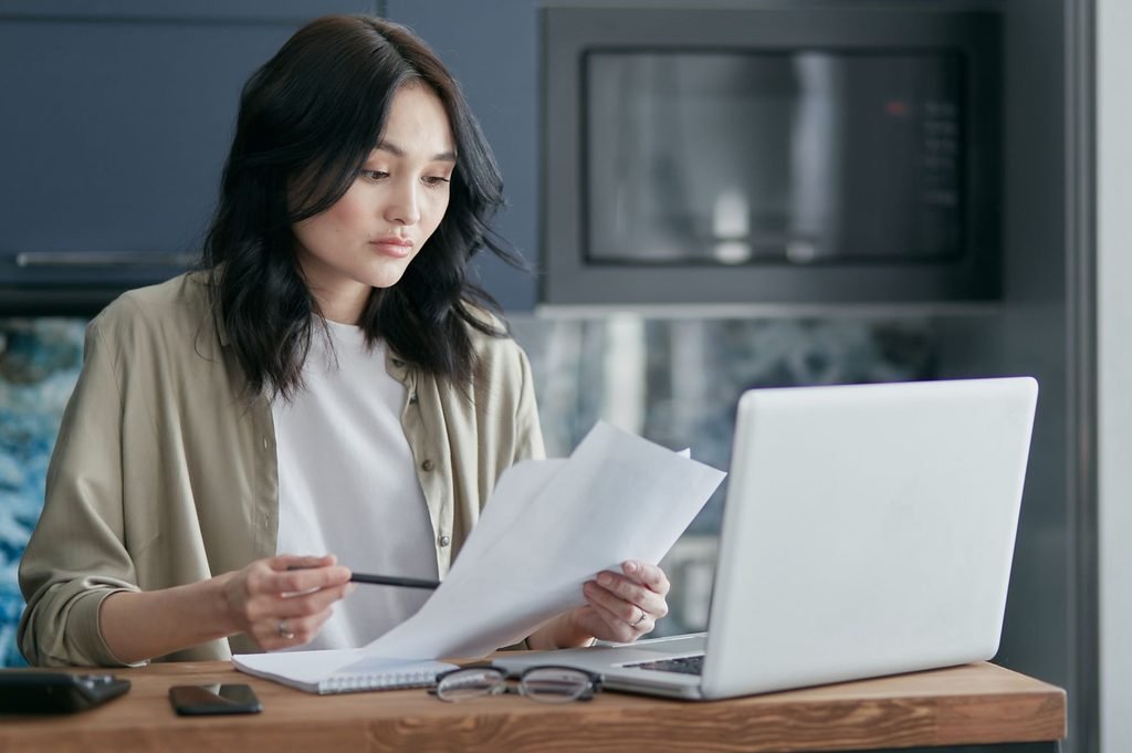 Professional reviewing documents as part of an outsourced translation project.