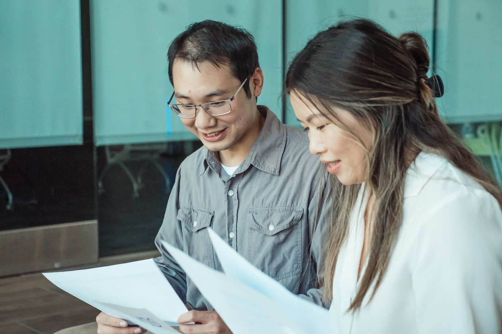 Two professionals carefully review technical manuals to ensure consistent terms and clear instructions.