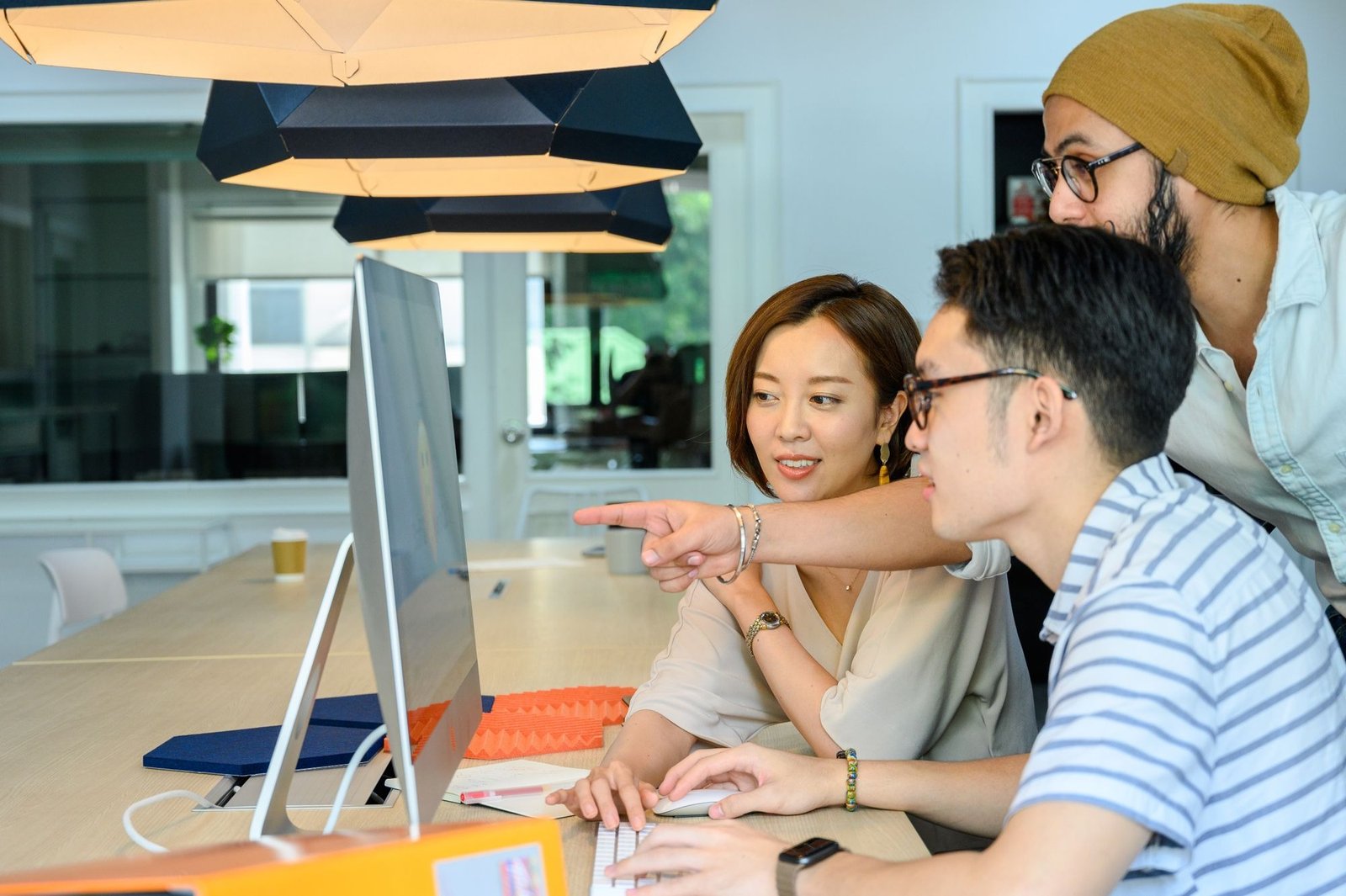 Diverse members of a global translation team review a document on a computer screen.