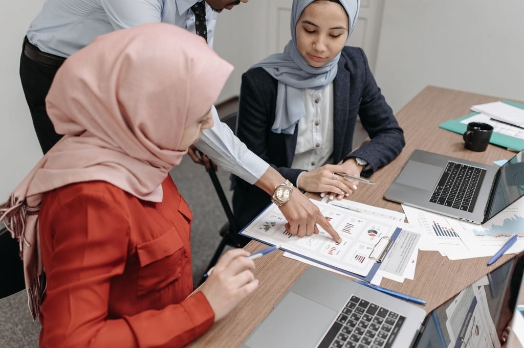Employees checking certified translation for accurate halal terminology.
